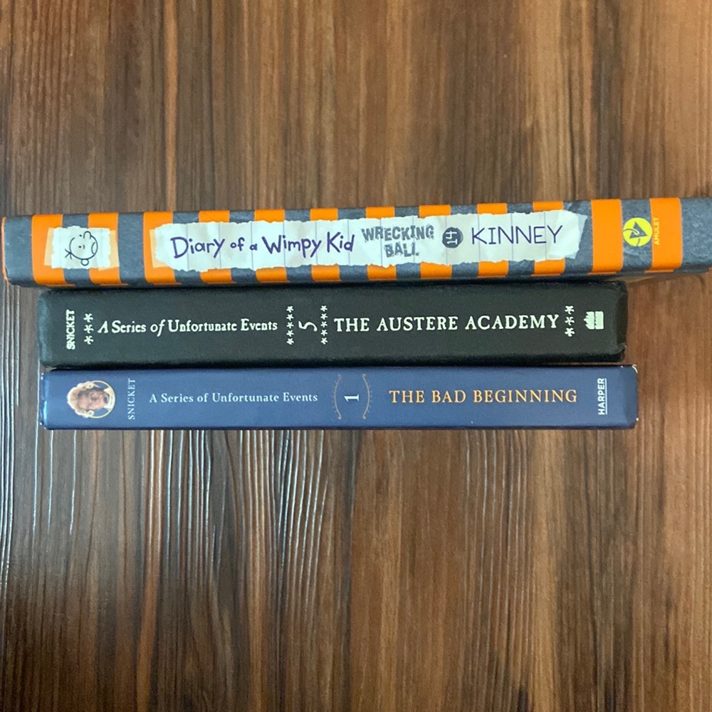 Hard cover books. 2 by Lemony Snicket, 1 by Jeff Kinney.